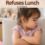 What I Serve My Toddler When She Refuses Lunch (1–3 Years) Toddler sitting at a dining table looking away from lunch, featuring easy lunch ideas and feeding tips for toddlers aged 1–3 years who refuse meals.