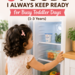 Why I Always Keep These 5 Foods Ready for Busy Toddler Days (1–3 Years) Toddler sitting at a kitchen table with simple healthy foods, representing five easy foods to keep ready for busy toddler days. Pinterest pin about quick toddler meal ideas for children aged 1–3 years.